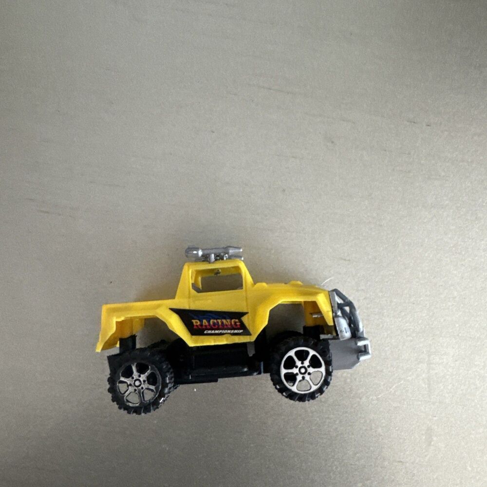 5" yellow plastic toy car with trunk bed and stickers on car